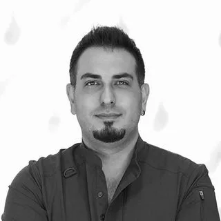 Uzm. Dt. Rouzbeh Fazelii — Periodontoloji, İzmir. Portre fotoğrafı.