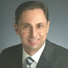 Dr. Dt. Kerim Türkoğlu — Ortodonti, İzmir. Portre fotoğrafı.